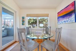 a dining room with a glass table and two chairs at Harbour House in Bodega Bay +19 photos