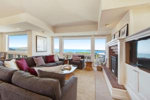 a living room with a couch and a television at Harbour House in Bodega Bay