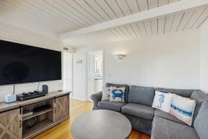 a living room with a couch and a flat screen tv at Sunset Escape in Bodega Bay