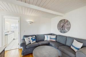 a living room with a couch and a clock on the wall at Sunset Escape in Bodega Bay +14 photos