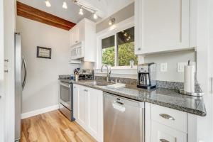 a kitchen with white cabinets and a sink at Whaleship Harbor View in Bodega Bay +27 photos