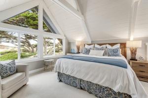 a bedroom with a large bed and a window at Whaleship Harbor View in Bodega Bay