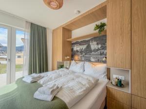 a bedroom with a large bed and a large window at Birdie Lodge in Sankt Lambrecht
