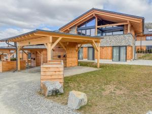 a large wooden house with a gambrel roof at Birdie Lodge in Sankt Lambrecht