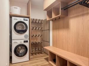 a laundry room with a washer and dryer at Birdie Lodge in Sankt Lambrecht