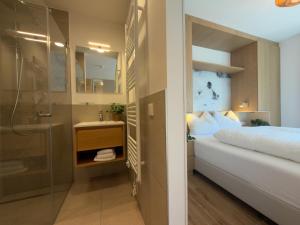 a bathroom with a shower and a bed and a sink at Birdie Lodge in Sankt Lambrecht +66 photos