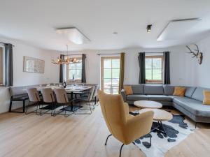 a living room with a couch and a table at Haus am Wald in Donnersbachwald