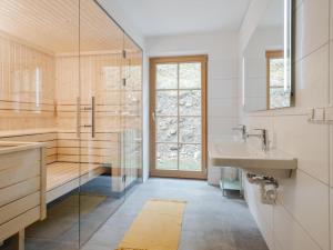 a bathroom with a sink and a shower at Haus am Wald in Donnersbachwald +19 photos