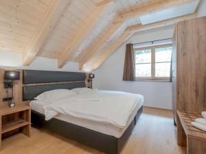 a bedroom with a large bed and a window at Haus am Wald in Donnersbachwald