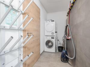 a laundry room with a washer and dryer at Haus am Wald in Donnersbachwald