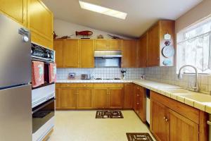 a kitchen with wooden cabinets and a sink at Pinnacle Heights in Bodega Bay