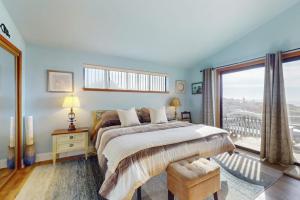 a bedroom with a bed and a large window at Pinnacle Heights in Bodega Bay