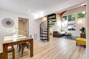 a living room with a table and a spiral staircase at Canyon House in Guerneville