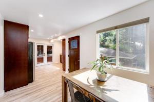 a kitchen with a table and a large window at Canyon House in Guerneville
