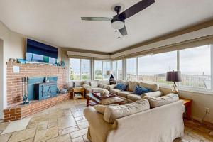 a living room with couches and a fireplace at Cozy Carmet Cottage in Bodega Bay