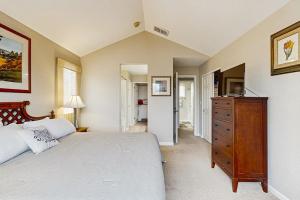 a bedroom with a large bed and a dresser in it at The Grape Escape in Santa Rosa