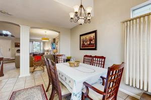 a dining room with a white table and chairs at The Grape Escape in Santa Rosa +19 photos
