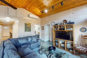 a living room with a blue couch and a tv at Villa Eileen in Guerneville