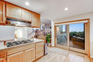 a kitchen with wooden cabinets and a view of a balcony at Latitude 38 in Bodega Bay