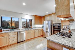 a large kitchen with wooden cabinets and stainless steel appliances at Latitude 38 in Bodega Bay +38 photos