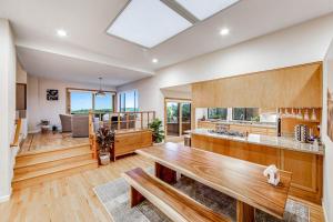 a large kitchen with a wooden table in a room at Latitude 38 in Bodega Bay