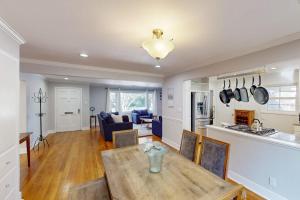 a kitchen and living room with a wooden table and chairs at James House in Santa Rosa