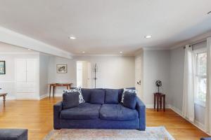 a living room with a blue couch and a table at James House in Santa Rosa