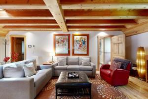 a living room with a couch and a red chair at Monte Rio Dream in Monte Rio