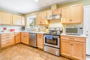 a kitchen with wooden cabinets and stainless steel appliances at Kenwood Retreat in Kenwood