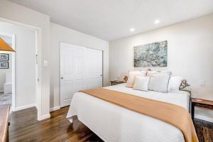 a bedroom with a large bed with white walls at Kenwood Retreat in Kenwood