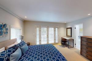 a bedroom with a blue bed and a desk at Warm Springs Paradise in Glen Ellen