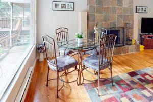 a glass table and chairs in a living room with a fireplace at River Paradise in Guerneville
