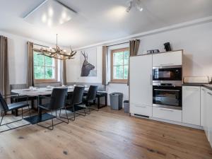 a kitchen and dining room with a table and chairs at Villa Petra in Donnersbachwald