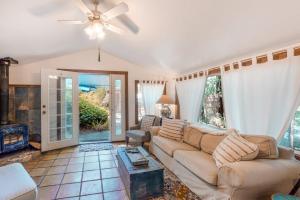a living room with a couch and a fireplace at Vineyard Cottage in Guerneville