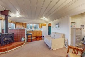 a living room with a couch and a stove at Seaside Cottage in Bodega Bay