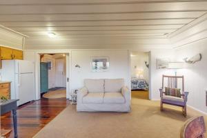 a living room with a white couch and a chair at Seaside Cottage in Bodega Bay +18 photos