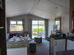 a kitchen and living room with a table and a couch at The Cosy Nook in Launceston