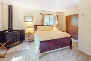 a bedroom with a bed and a wood stove at Redwood Lodge in Monte Rio
