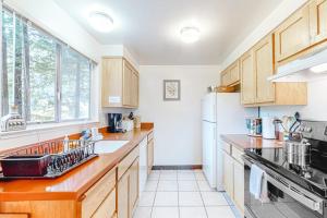 a kitchen with wooden cabinets and a white refrigerator at Redwood Lodge in Monte Rio +17 photos
