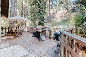 a wooden deck with a table and an umbrella at Redwood Lodge in Monte Rio