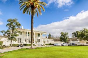 a palm tree in front of a white house at Silverado Resort and Spa 266 & 267 in Napa