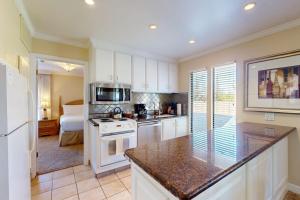 a kitchen with white cabinets and a counter top at Silverado Resort and Spa 266 & 267 in Napa