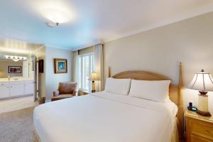 a bedroom with a large white bed and a bathroom at Silverado Resort and Spa 266 & 267 in Napa