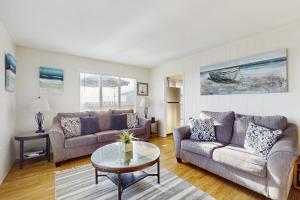 a living room with two couches and a table at Coastal Dream in Bodega Bay