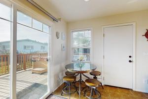 a room with a table and chairs and a balcony at Coastal Dream in Bodega Bay +17 photos