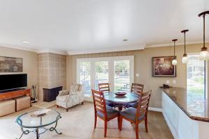 a living room with a table and chairs and a television at Silverado Resort and Spa 287 & 288 in Napa