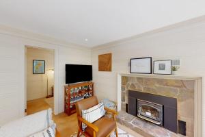 a living room with a fireplace and a tv at Hidden Acres Retreat in Guerneville