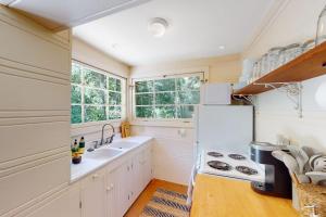 a kitchen with a sink and a refrigerator at Hidden Acres Retreat in Guerneville