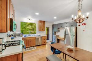 a kitchen with a table and a refrigerator at Caz Cabin 6 in Cazadero