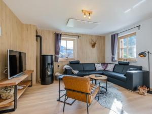 a living room with a couch and a tv at Haus Laura in Donnersbachwald